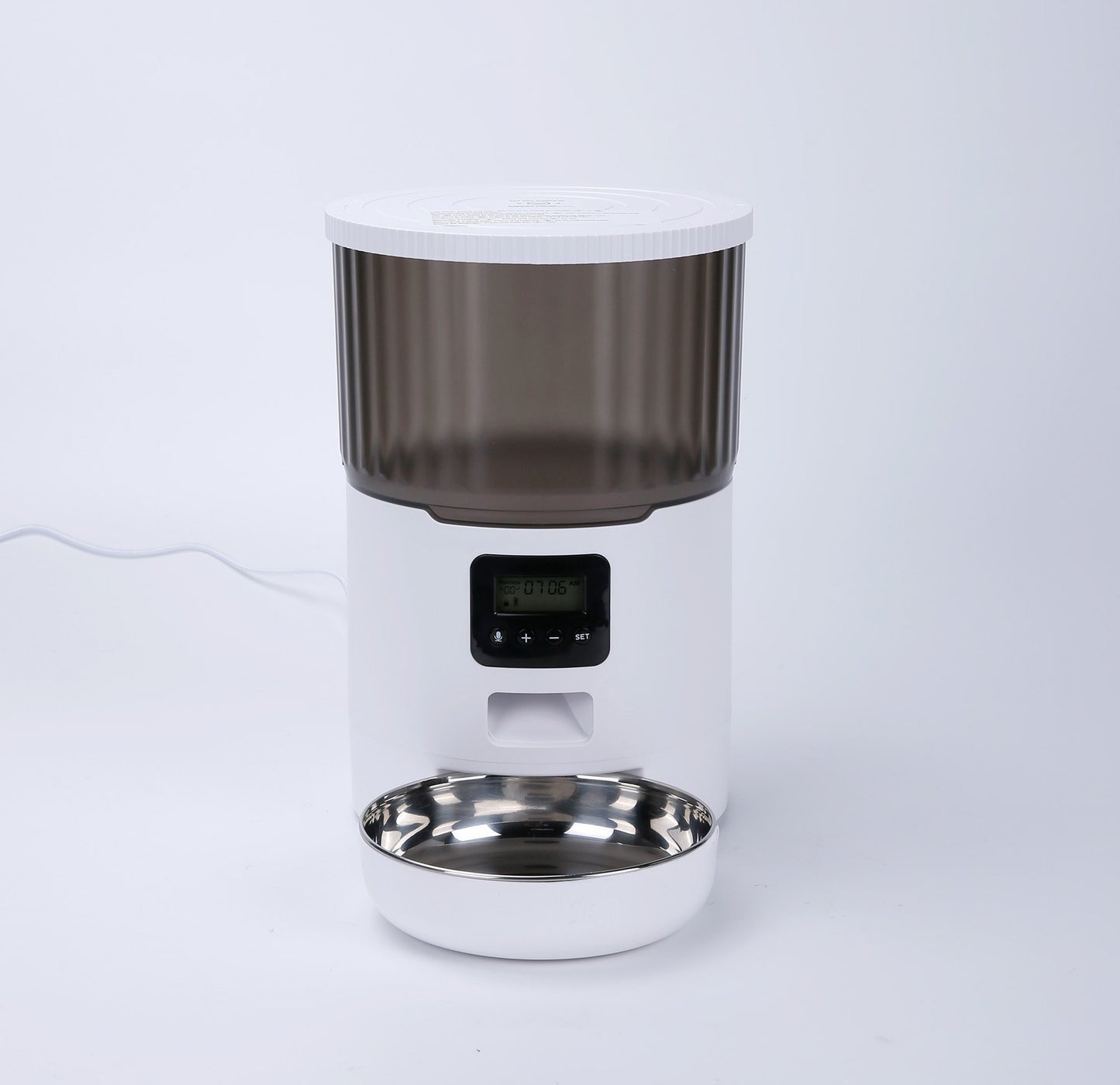 White pet water fountain with a transparent drinking bowl on a white background