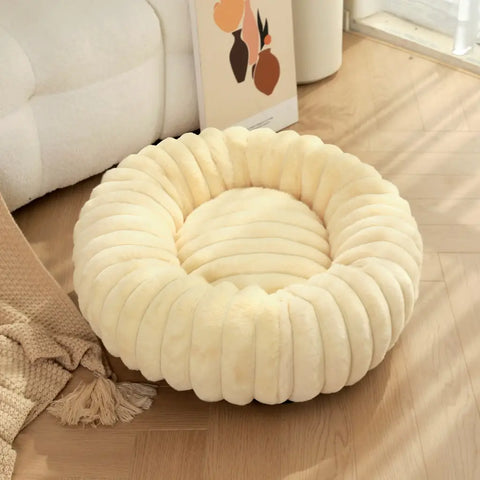 Beige round pet bed with cozy plush filling and decorative ribbed texture