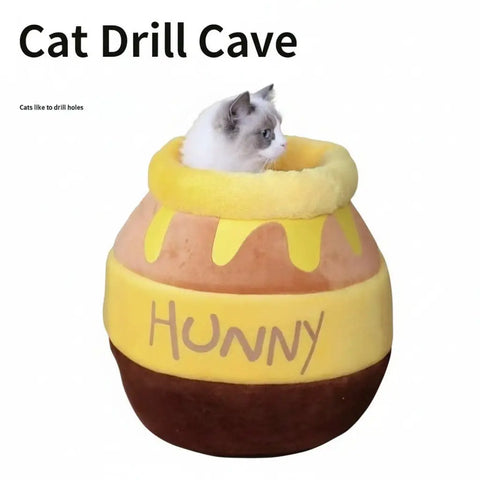 Cat lying inside honeycomb-shaped pet bed with 'HUNNY' text.