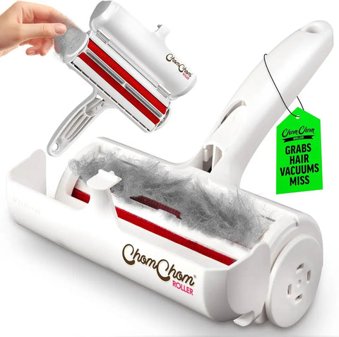 White ChomChom Roller pet hair remover with an open waste compartment filled with collected fur.