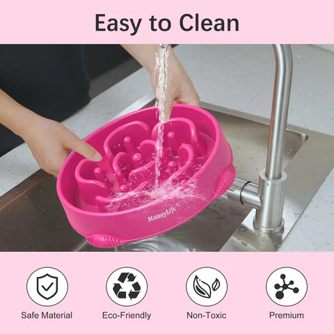 Person washing a pink MateeyLife slow feeder bowl under a faucet highlighting non-toxic and eco-friendly materials.