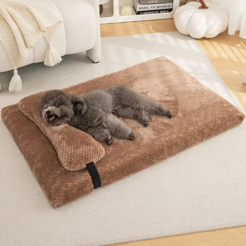 Fluffy black dog resting on a soft brown pillow bed in a warm home setting