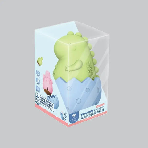 Green dinosaur-shaped dog chew toy in clear packaging box, made from durable non-toxic rubber, designed for dental health and teething relief, perfect for playful puppies and adult dogs, PawVortex USA.