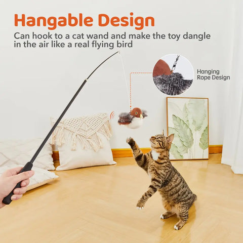 Kitten jumping for hangable sparrow toy attached to cat teaser wand