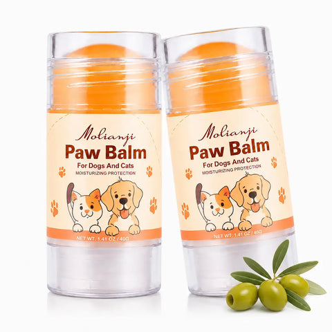 Two sticks of Molianji 40g natural paw balm for dogs and cats next to green olives.