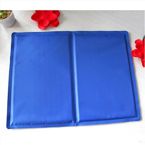 Pet cooling mat on white surface with decorative red flowers.