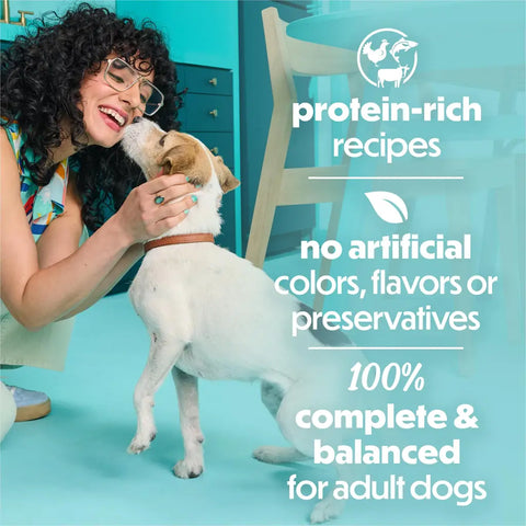 Happy woman with a small dog and text highlighting 100% complete and balanced nutrition for adult dogs.