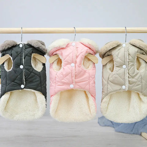 Quilted pet coat collection on a rack in gray, pink, and beige with faux fur trim