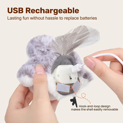 Hands connecting USB charging cable to the removable battery pack inside the plush bird cat toy