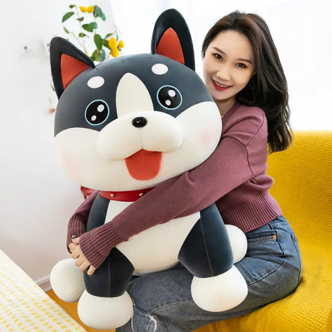 Woman hugging a large, soft plush dog toy on a bright yellow couch for emotional comfort