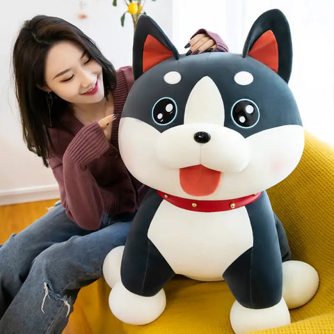 Woman relaxing with a large premium plush dog toy on a yellow couch for luxury companionship