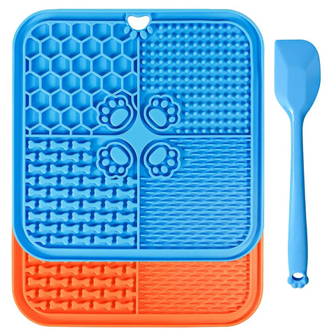Two pack pet lick mats in blue and orange colors featuring four texturized quadrants with a blue spreading spatula.