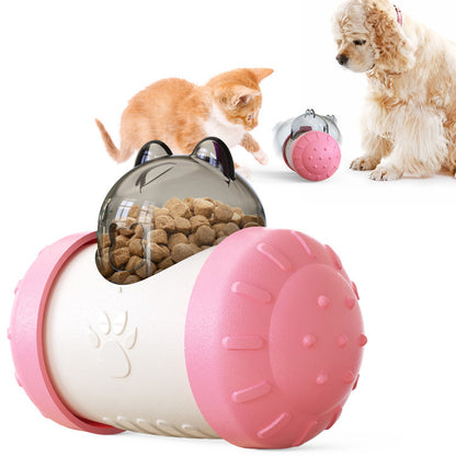 Pet toy with a transparent lid revealing kibble, surrounded by a cat and a dog on a white background.