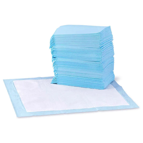 Stack of blue disposable dog training pads next to a open absorbent pee pad