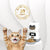 Cat with paws raised next to an automatic pet feeder with a money back guarantee badge