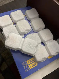 Customer review image showing a 6-pack box of replacement filters next to white carbon cartridges and black pre-filter foam sponges on a wooden table.