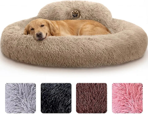 Golden retriever sleeping comfortably in a large beige soft faux fur donut bed