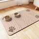 Beige absorbent pet feeding mat with brown paw print accents for dogs and cats.