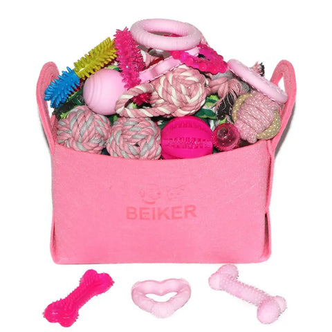 Pink felt storage basket branded Beiker filled with pink and white puppy chew toys