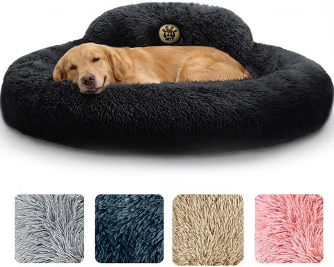 Golden retriever resting inside a large black fluffy round donut pet bed