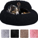 Medium dog resting inside a black plush calming donut pet bed with raised backrest