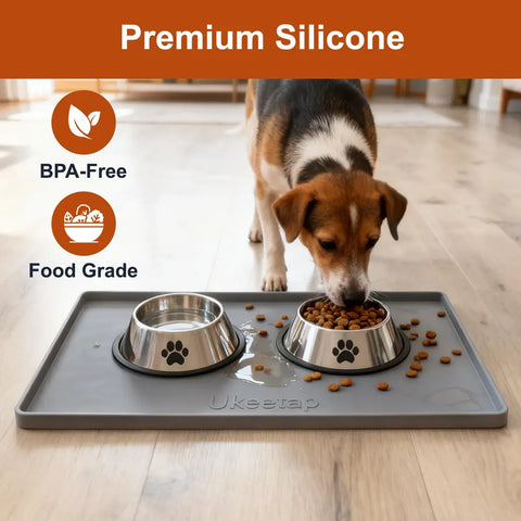 Beagle dog eating kibble from a stainless steel bowl placed on a premium grey food-grade silicone mat.