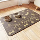 Dark brown pet food mat with tan bone and paw print patterns and "Pet Food Mat" text.