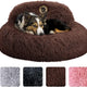 Medium dog resting comfortably in a dark brown plush calming donut bed
