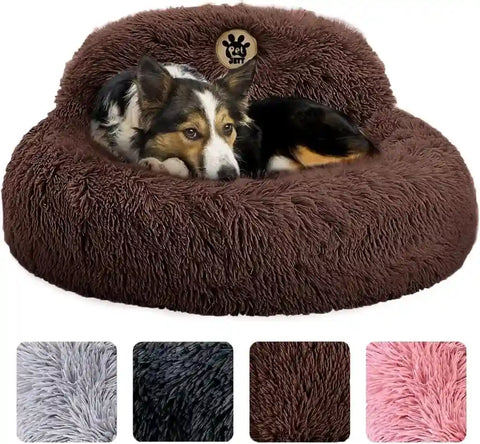 Medium dog resting comfortably in a dark brown plush calming donut bed