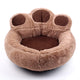 Brown paw-shaped pet bed on a white background.