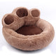 Brown paw-shaped pet bed on white background view.