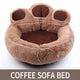 Brown paw-shaped pet bed on white background.