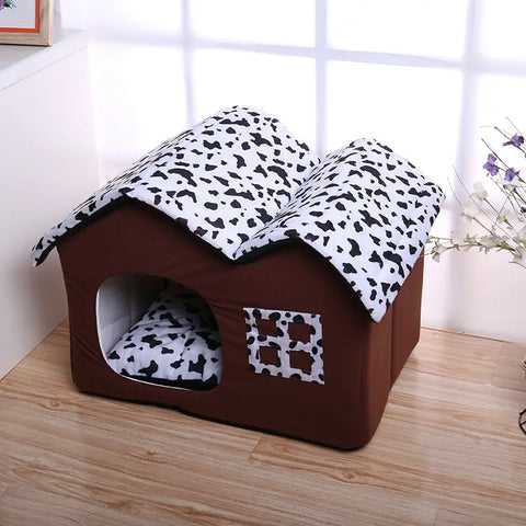 Brown pet house with a leopard print cover on wooden floor.