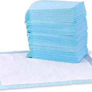 A large stack of blue leak-proof dog pee pads next to an unfolded white training pad