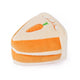 Triangular slice of plush carrot cake dog toy with orange frosting layers and embroidered carrot detail.