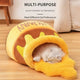 Cat bed shaped like a hot dog with a cat inside on wooden floor.