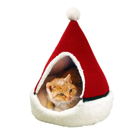 Cat peeking out from a red and white Santa hat-shaped pet bed.