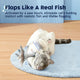 Cute cat lying on a rug playing with a motion-activated flopping fish toy.