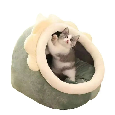 Cat sitting in a cozy pet bed with white interior and beige exterior.