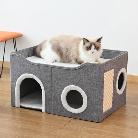 Cat sitting on a gray cat house with a white background.