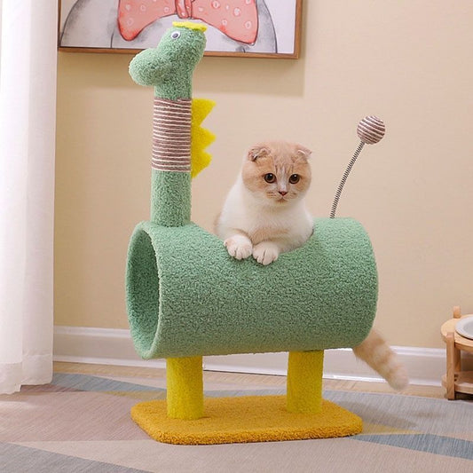 Cat sitting on a green dinosaur-shaped cat tree in a room with a painting on the wall.