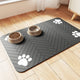 Charcoal grey pet food mat with white paw prints and herringbone texture on wood floor.