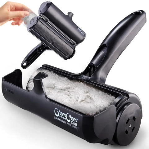 Black ChomChom Roller Elite Series pet hair remover with open chamber holding collected pet fur.