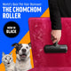 Person using the black ChomChom Roller pet hair remover to clean dog and cat fur off a velvet chair.