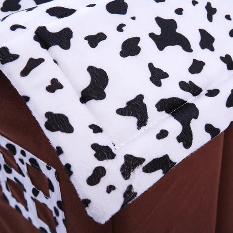 Close-up of brown fabric with white border featuring black abstract shapes.