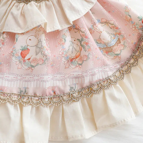 Close-up of decorative fabric with floral patterns and lace trim.