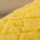 Close-up of yellow pineapple with brand name 'Pineapple Hut'.