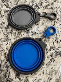 Customer photo of navy blue and gray collapsed silicone dog bowls placed on a granite countertop