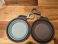 Flatlay customer review photo of collapsed sky blue and gray silicone travel pet bowls on a wooden surface