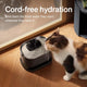 Wireless battery-operated cat water fountain used by a calico cat on hardwood floor